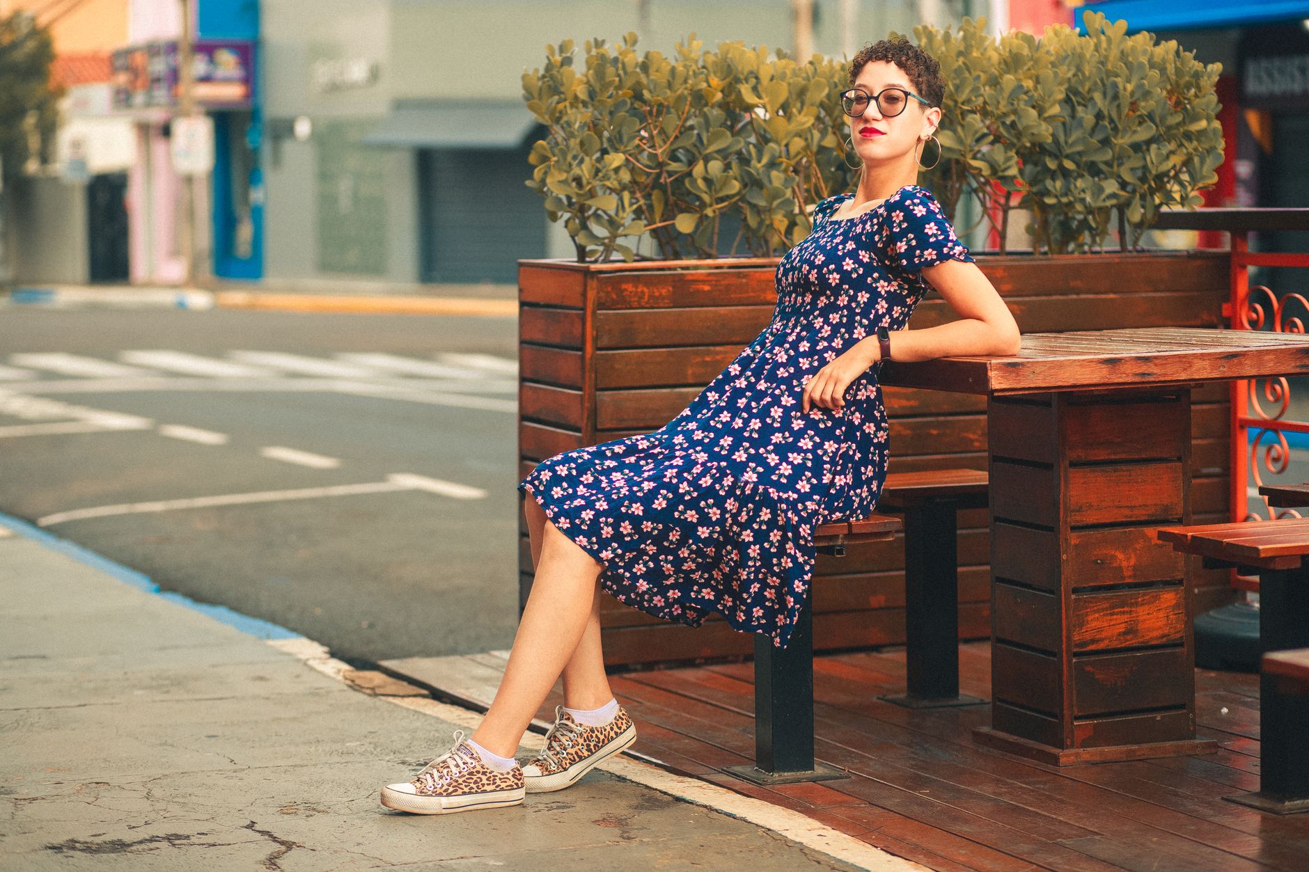 Woman wearing a floral midi dress outdoors in warm summer light