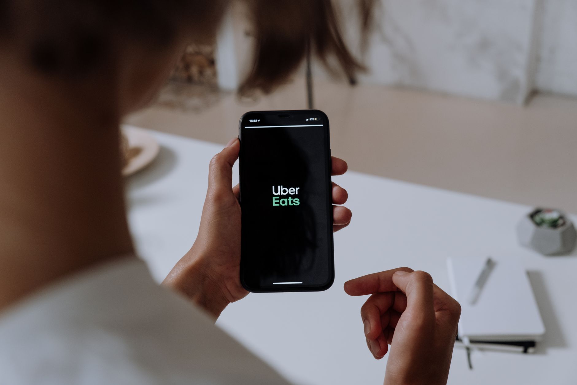 Person using a delivery app on smartphone to order products