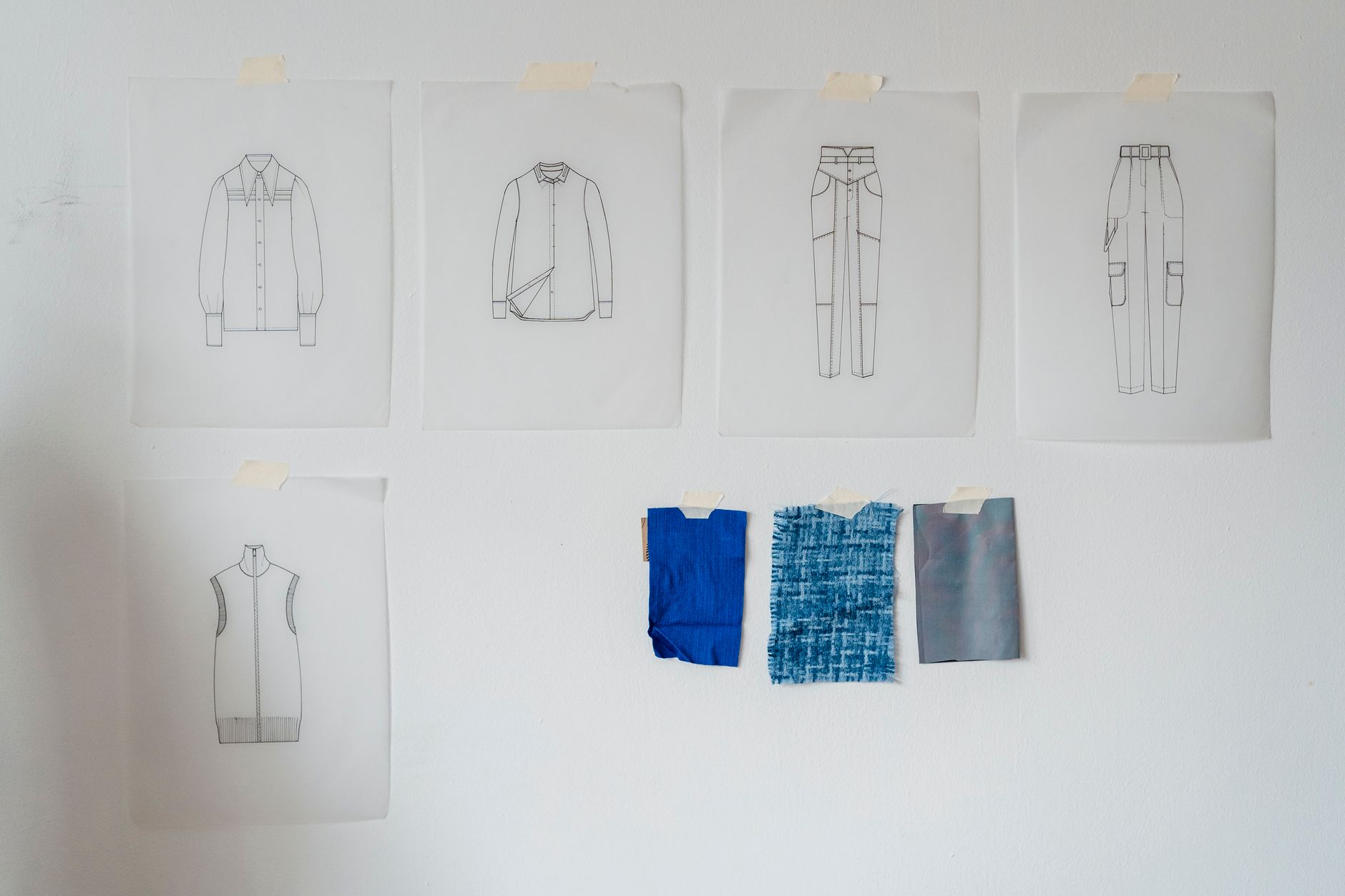 Designer garments hanging in a fashion archive or atelier, evoking heritage and craftsmanship