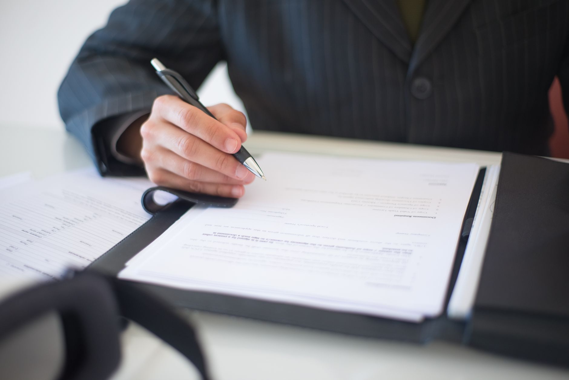Legal documents and counsel papers spread across an office desk