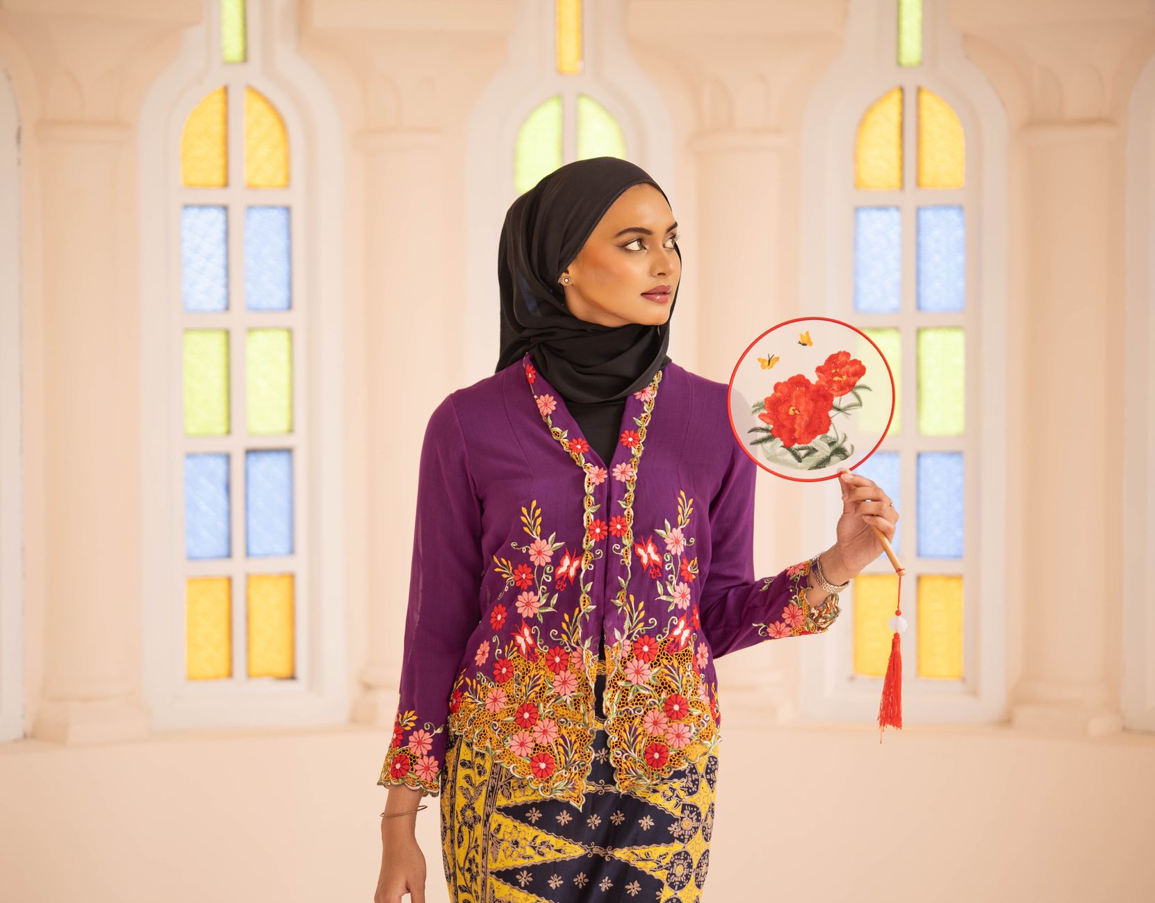 A detailed embroidered floral jacket with feather trim, fashion editorial style