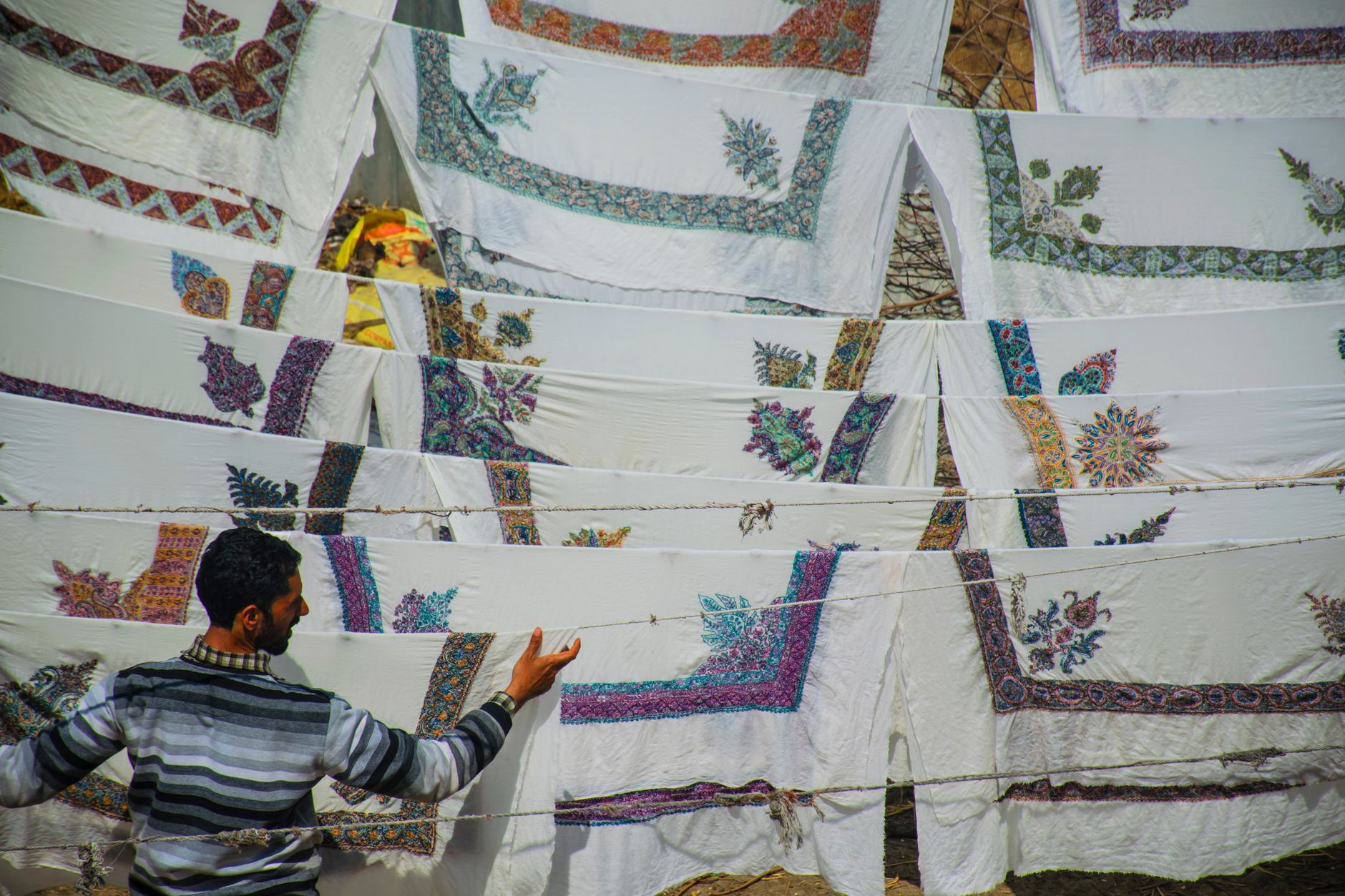 Detailed embroidery and feather work on fine fabric