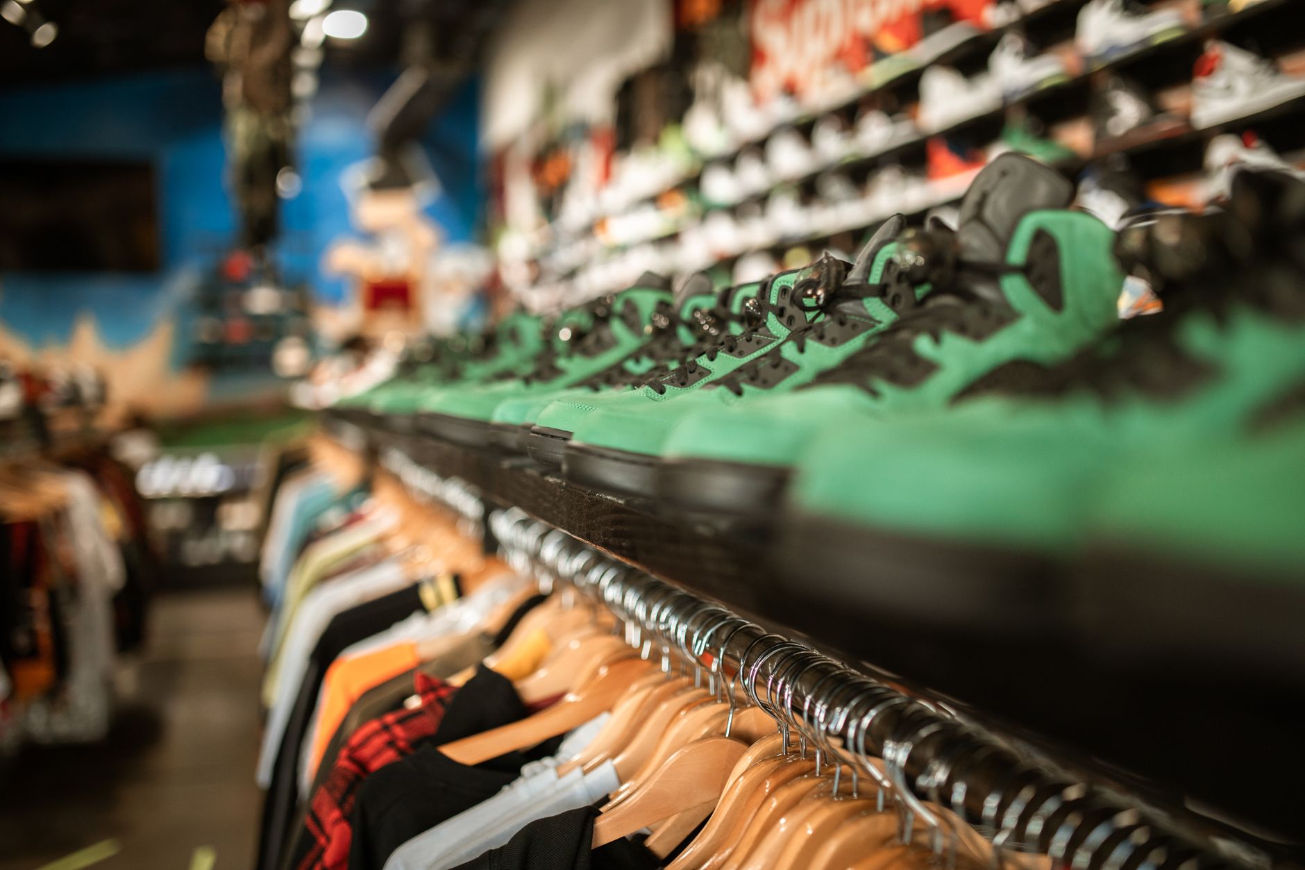 Athletic sneakers displayed on retail shelving in a footwear store