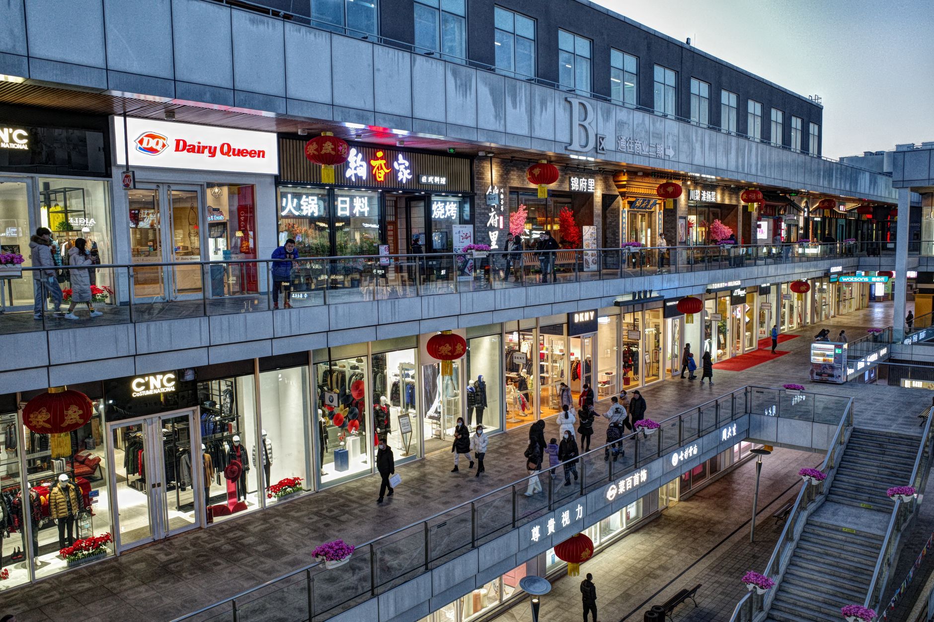 Bright interior of a large modern Chinese shopping mall with open plaza space