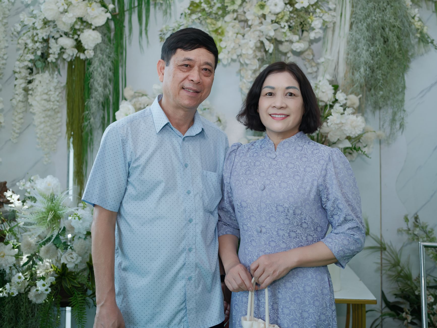 Two people at a public media press event on a red carpet