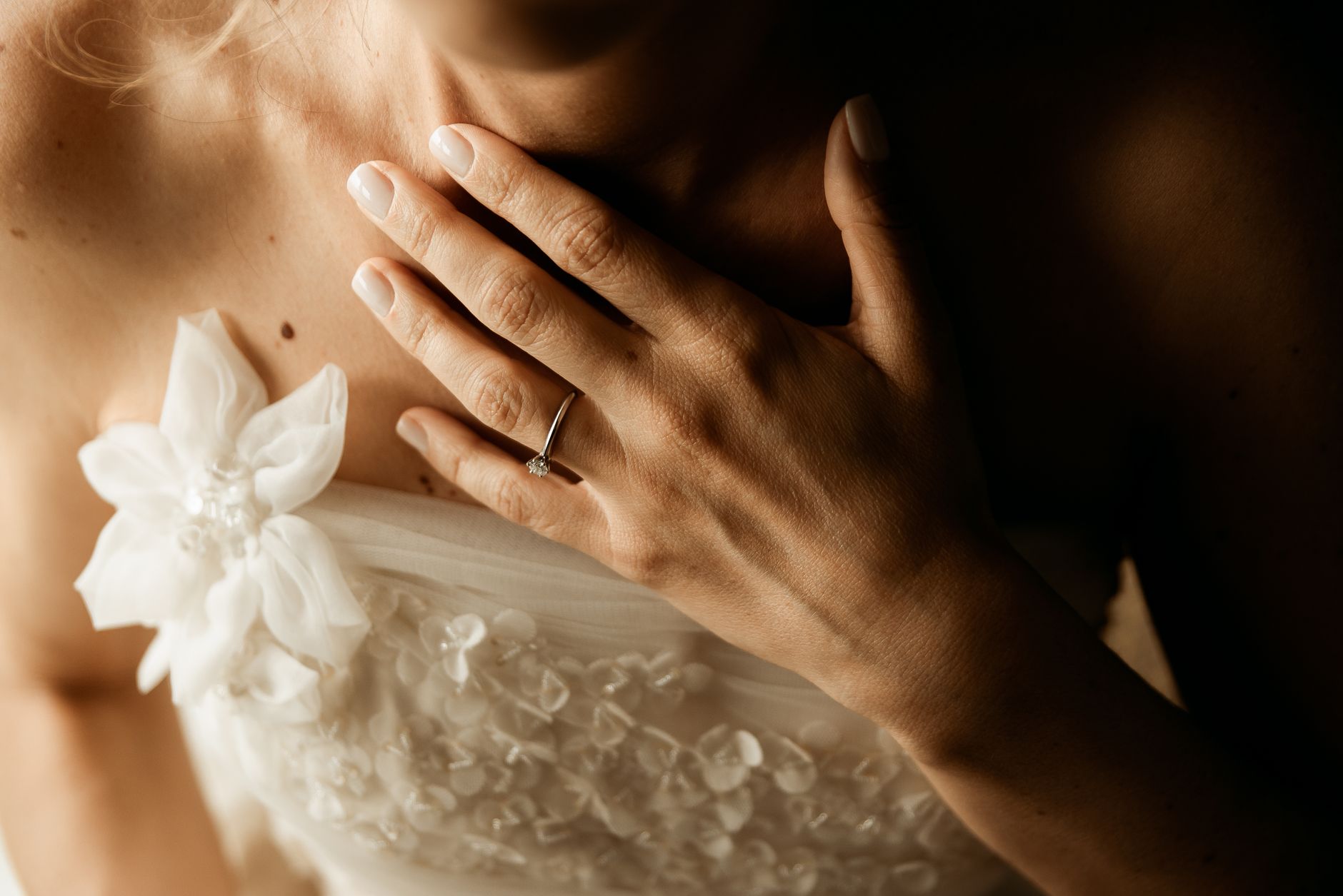 Close-up of elegant bridal shoes and gown fabric at a formal wedding