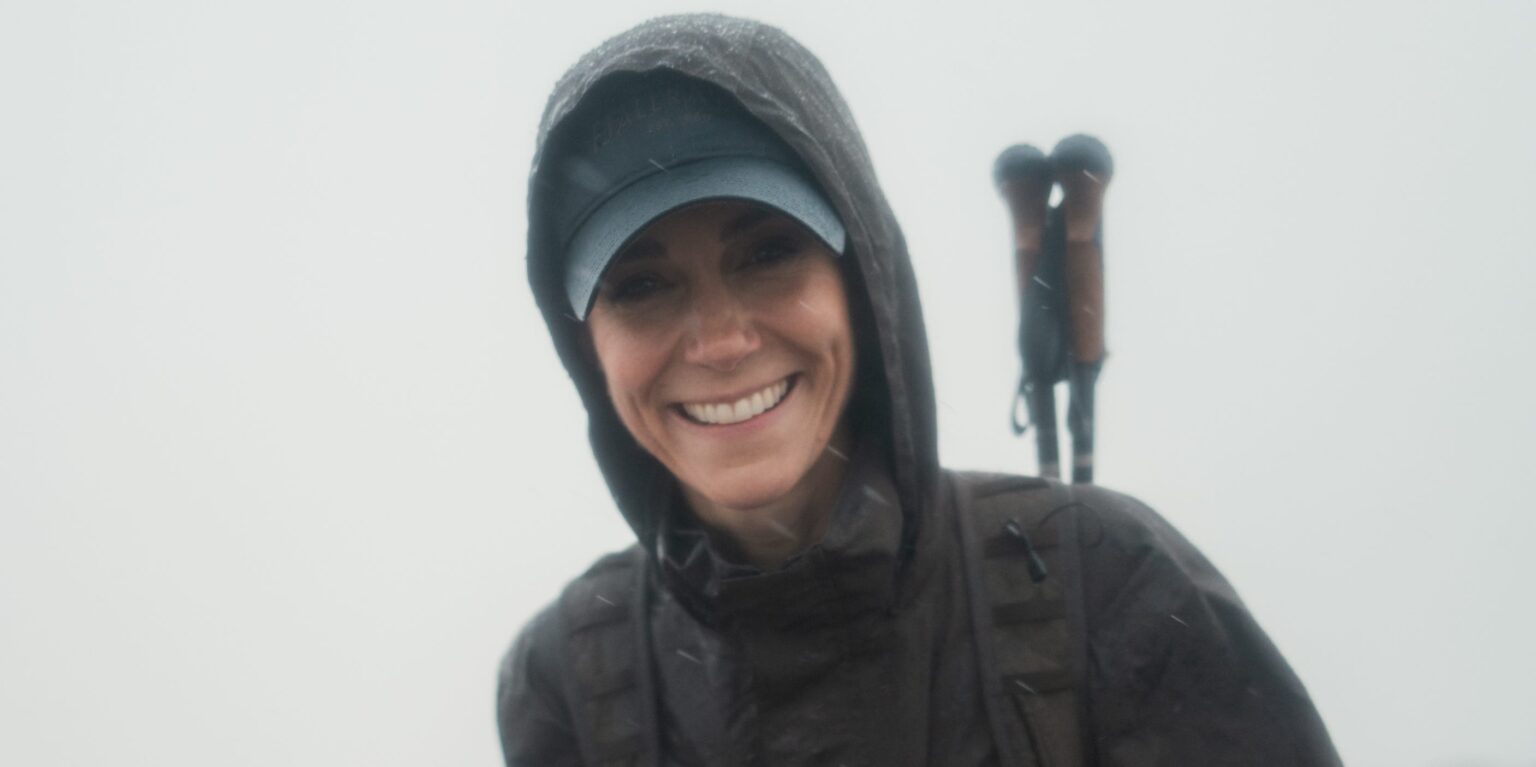 Princess Kate Takes On Three Peaks Challenge After Cancer Treatment A hiker on a rugged mountain trail with dramatic sky overhead