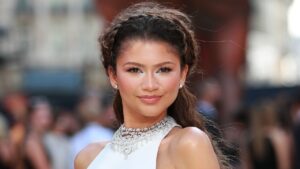 Woman with long waist-length wavy hair styled with a braid crown detail