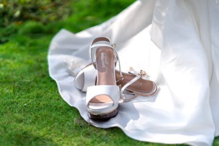 Reformation and Enya Umanzor Revive the Wedge With a $298 Satin Shoe Close-up of a satin wedge heel shoe with embroidered detailing on the upper