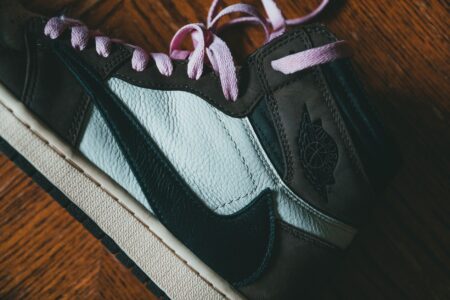 Close-up of a sneaker in earth brown and mint green tones on a neutral surface