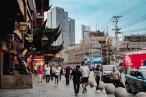 Luxury shopping street in Shanghai with high-end retail facades and pedestrian traffic