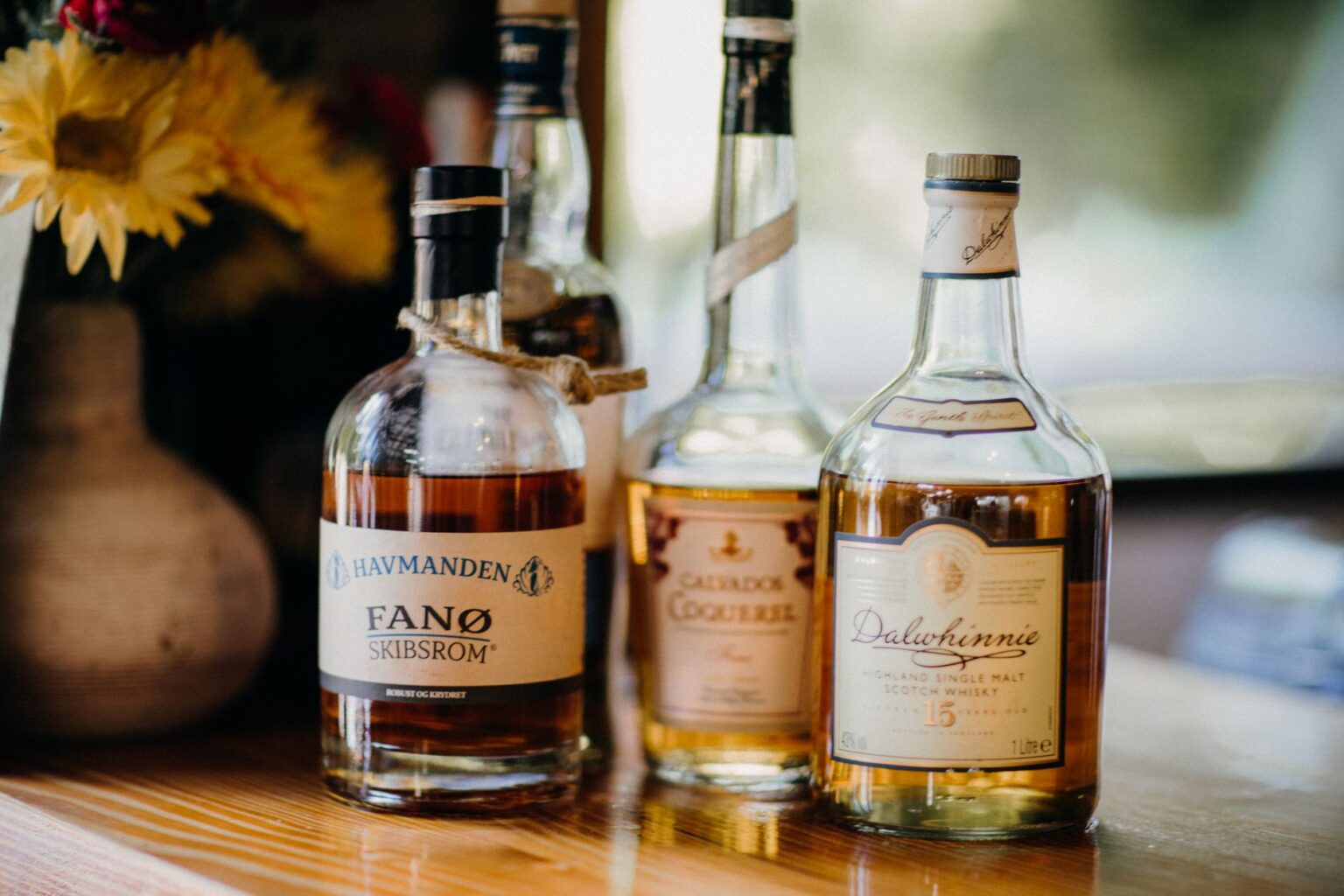 James Marsden and Son Jack Front The A glass of amber whisky resting on a dark wooden table, evoking luxury and patience