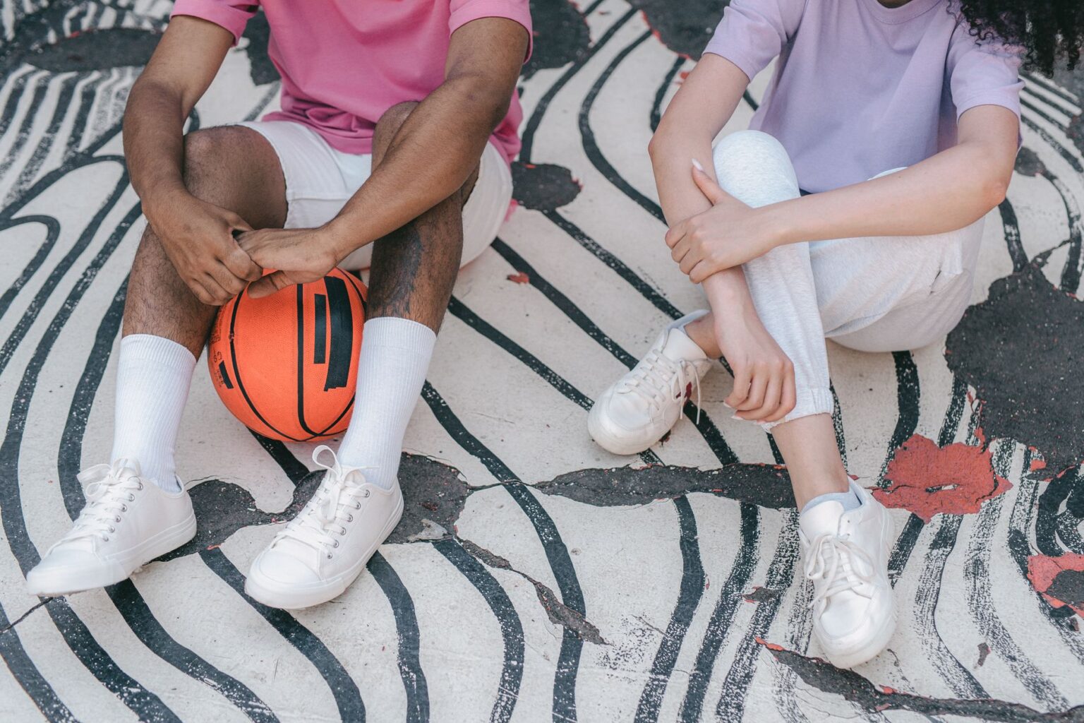 Bright graphic-printed basketball shoes displayed against a neutral background