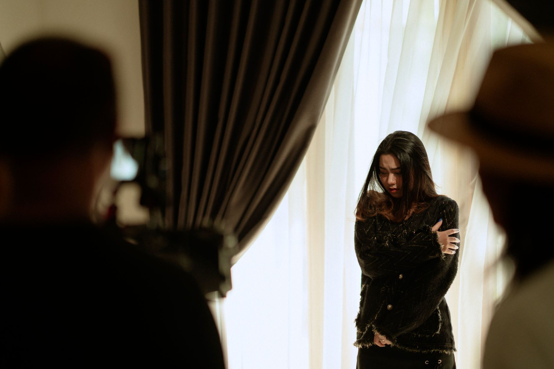 Young woman in a studio audition setting, looking into the distance
