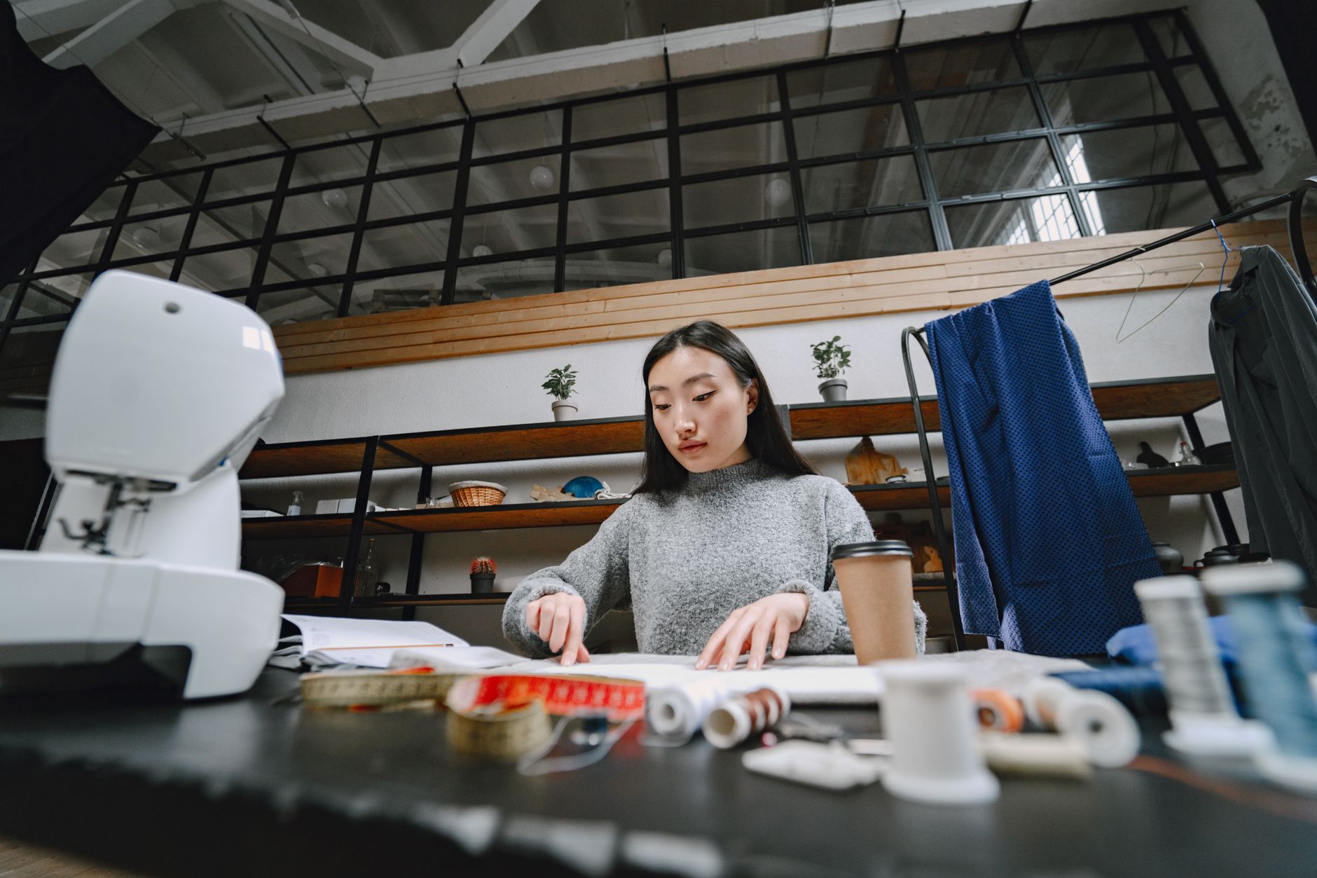 Designer reviewing fabric swatches and sketches in a creative studio
