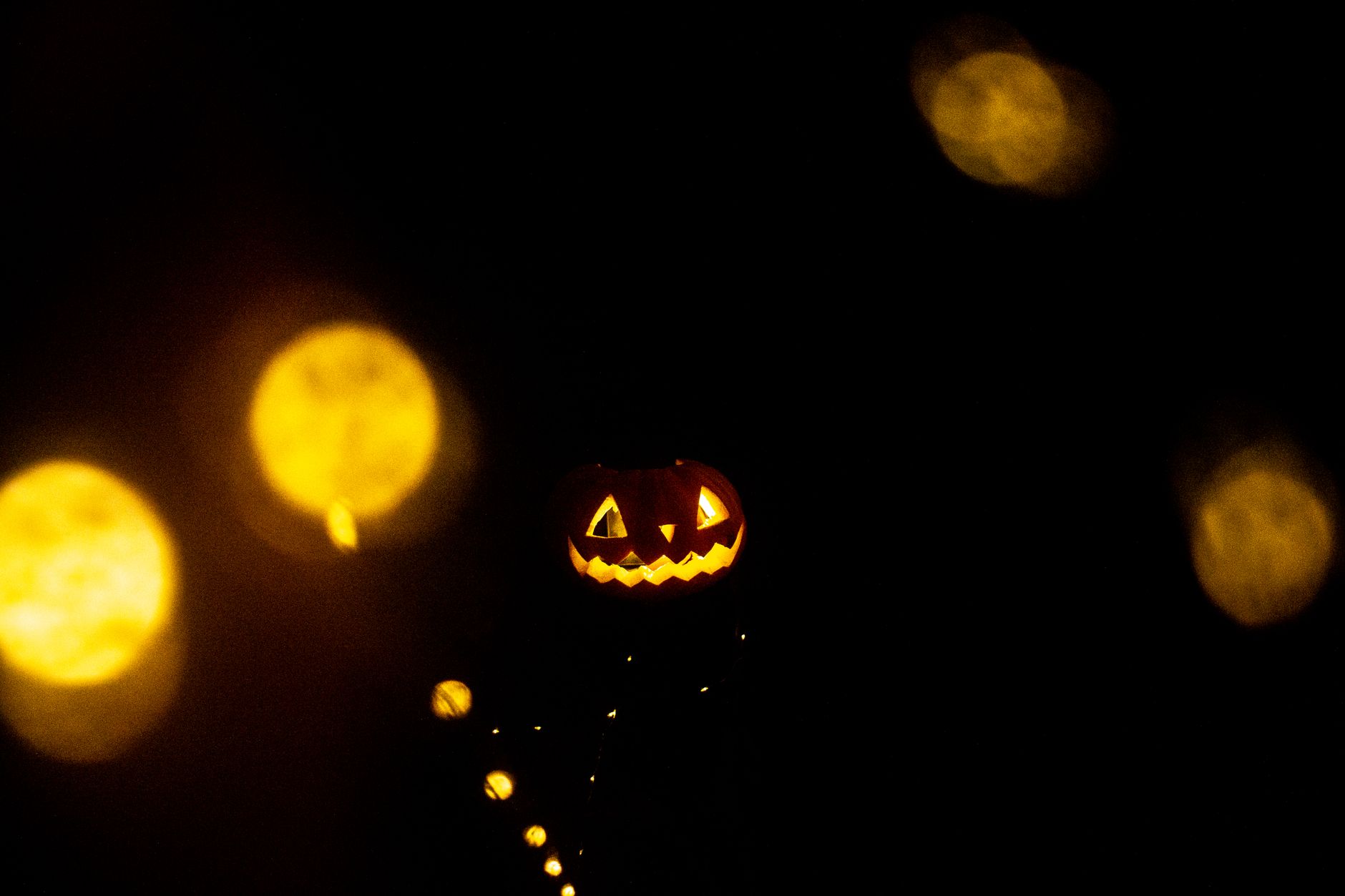 Glowing objects photographed in darkness evoking Halloween atmosphere