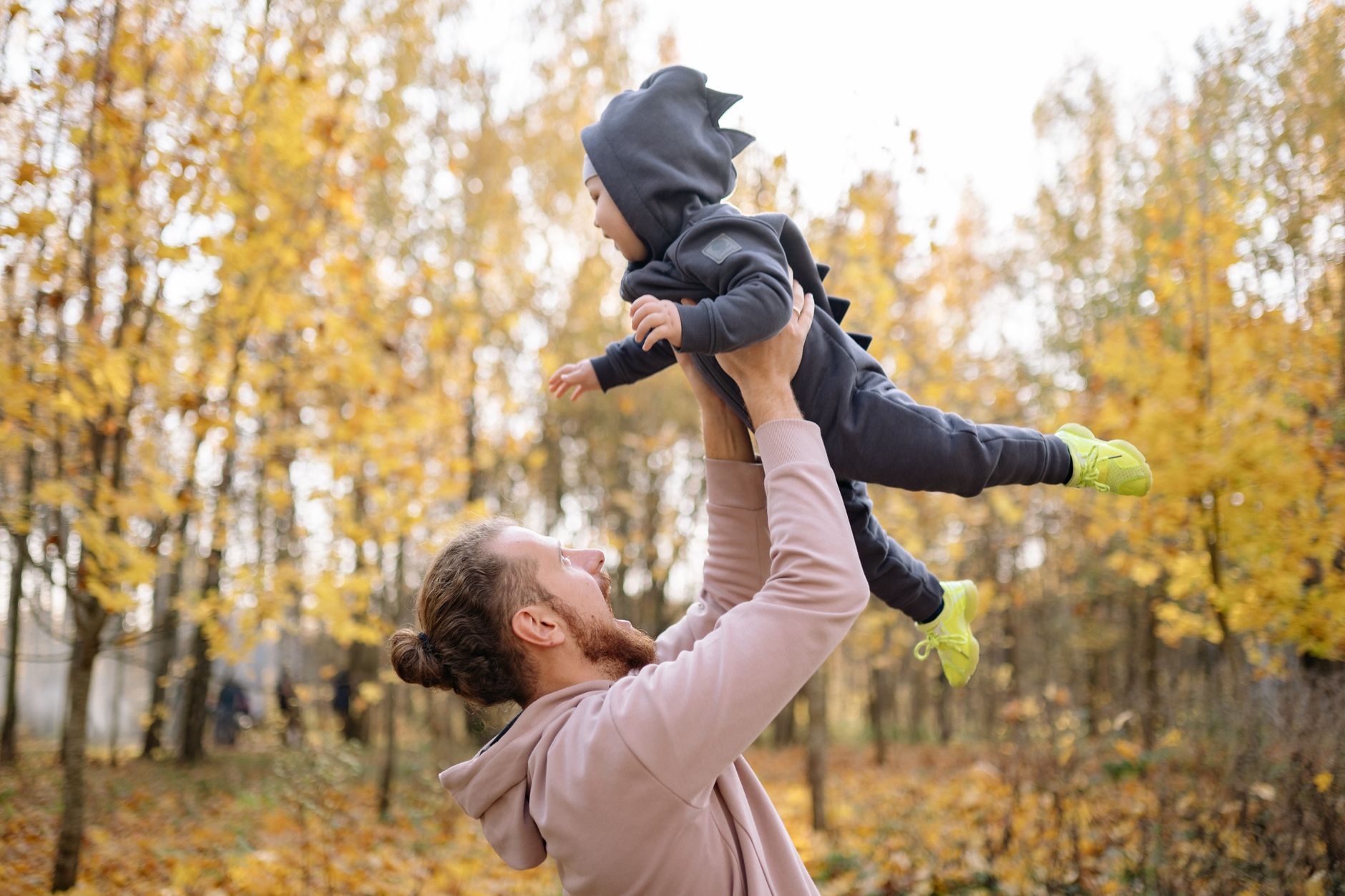 A father and son standing together outdoors, representing generational connection