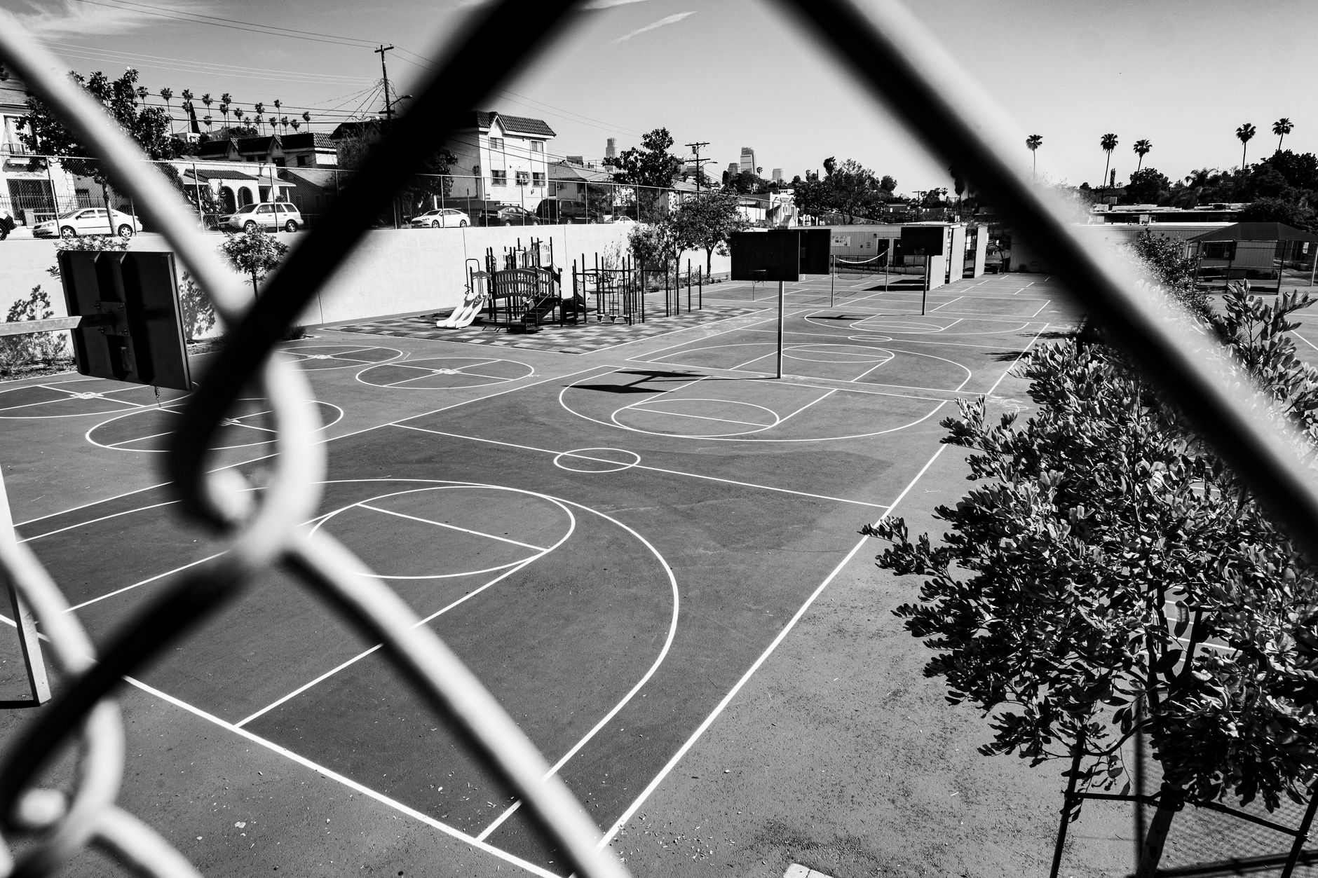 Indoor basketball court with dramatic lighting and hardwood floor detail