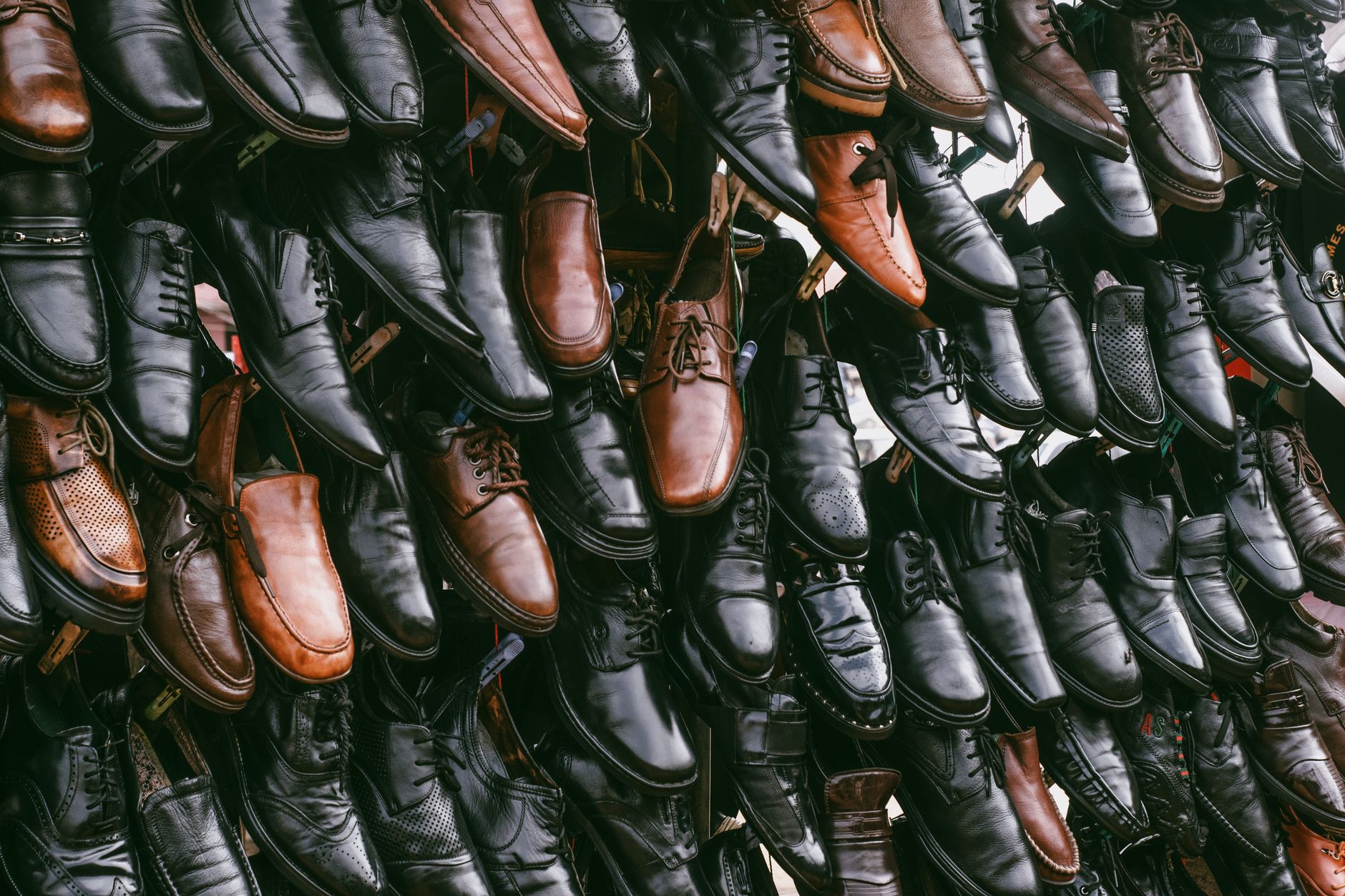 Premium sneakers displayed on a minimal retail surface in soft natural light