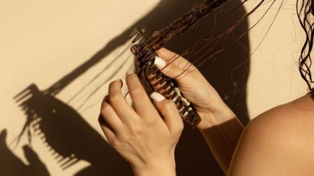 Tirzepatide Linked to Higher Hair Loss Risk Than Other GLP-1 Drugs Close-up of a hairbrush with shed strands, representing hair loss concerns