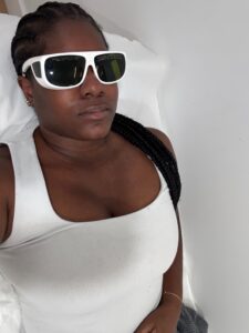 A person preparing for a laser skin treatment in a clinical setting