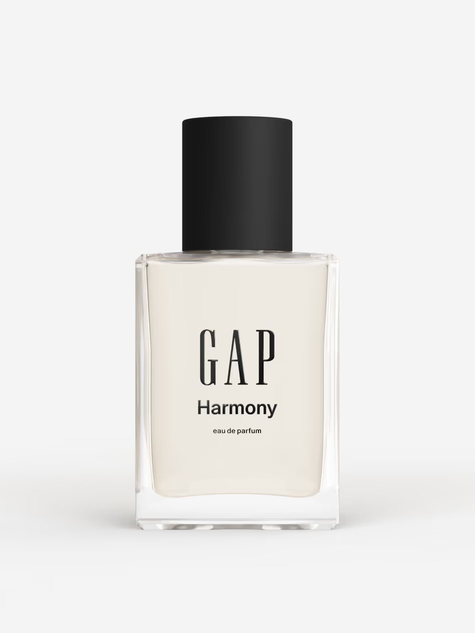 Woman spritzing fragrance on her wrist while getting ready