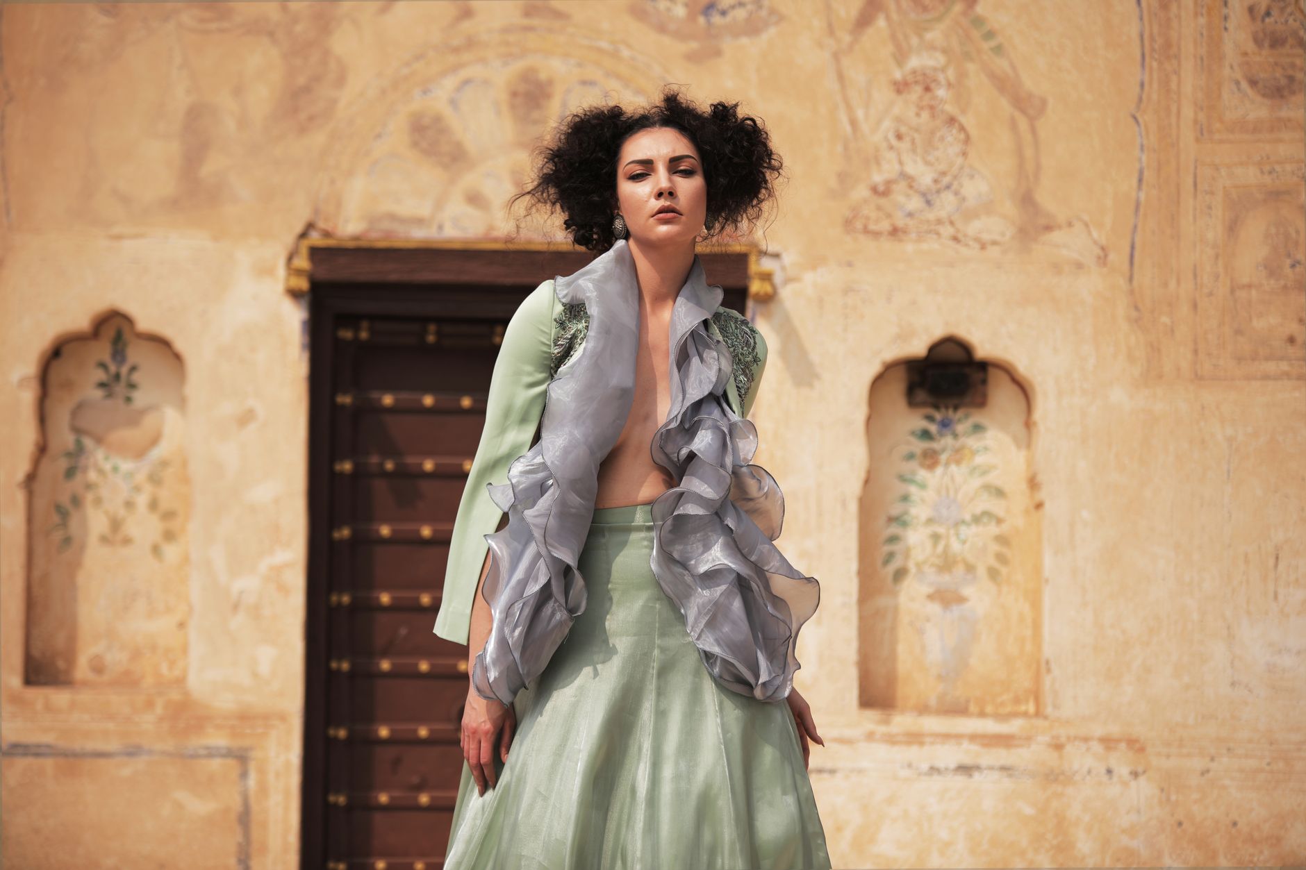 Model wearing ruffle-detailed fashion garment in editorial setting