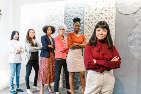 Two women executives in professional setting discussing business strategy
