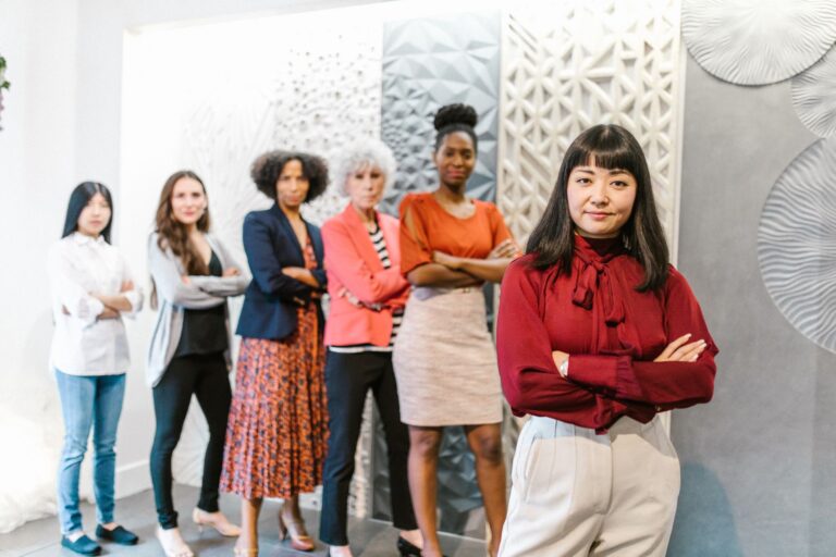 Two women executives in professional setting discussing business strategy