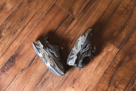 Black athletic sneakers displayed on a clean surface representing futuristic footwear design