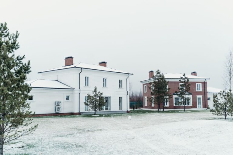 White House front facade on a clear day, formal grounds visible