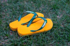 MM6 Maison Margiela Adds a Sixth Toe to Havaianas in Milan Bright rubber flip-flops laid flat on a white surface