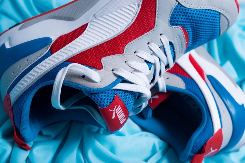 Close-up of a blue athletic sneaker with sleek paneling and heel detail