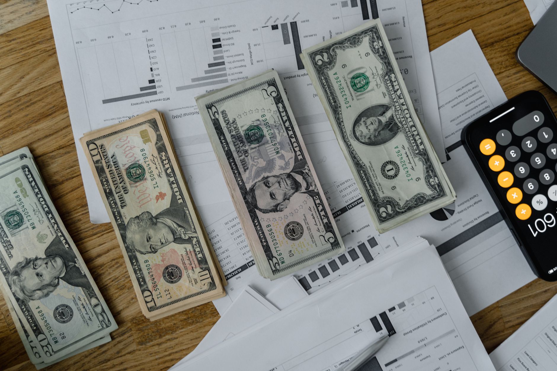 Executives gathered around a table reviewing financial reports during a quarterly earnings presentation