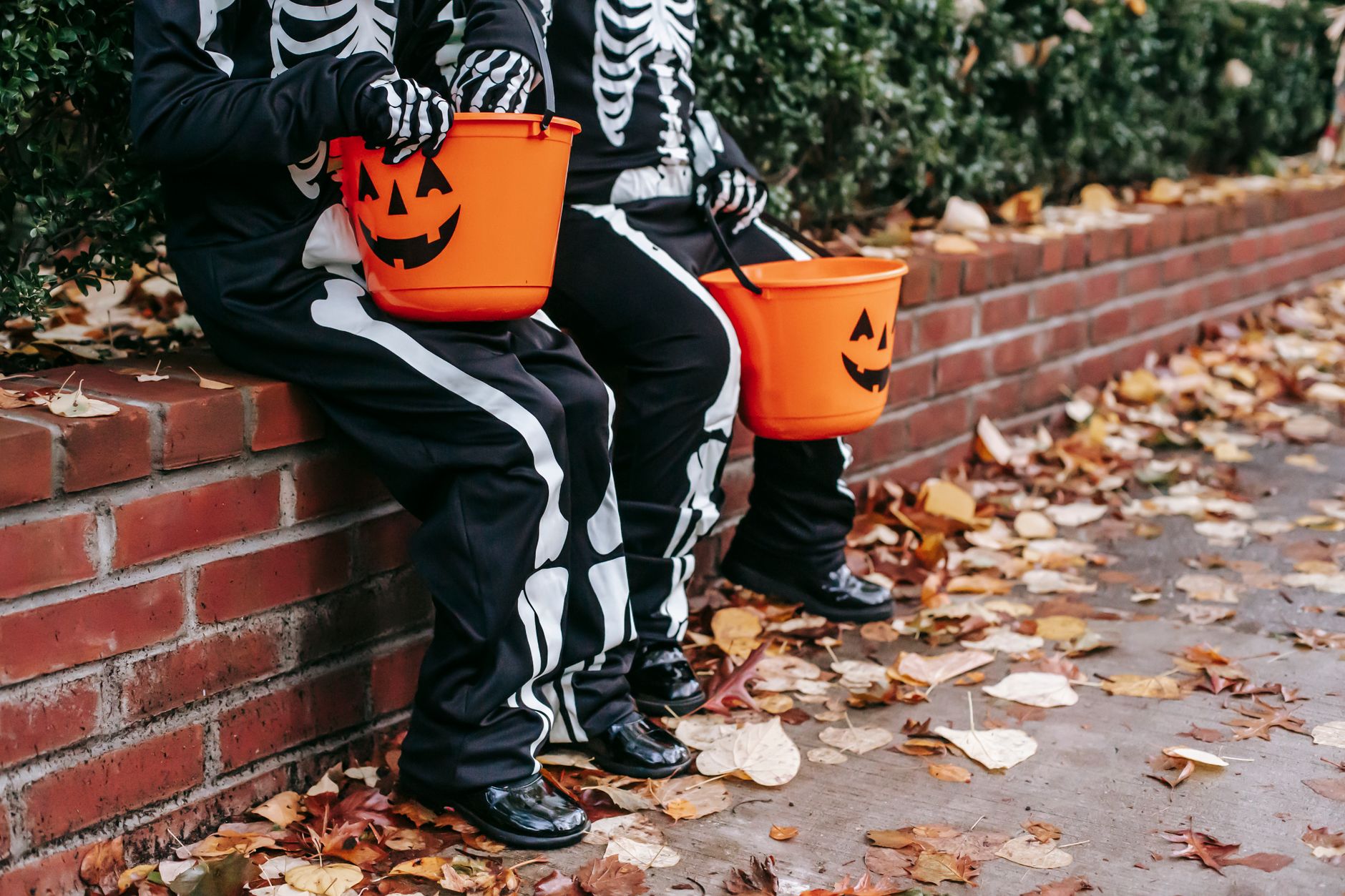 Children's Halloween costume with dark shoes on a wooden floor