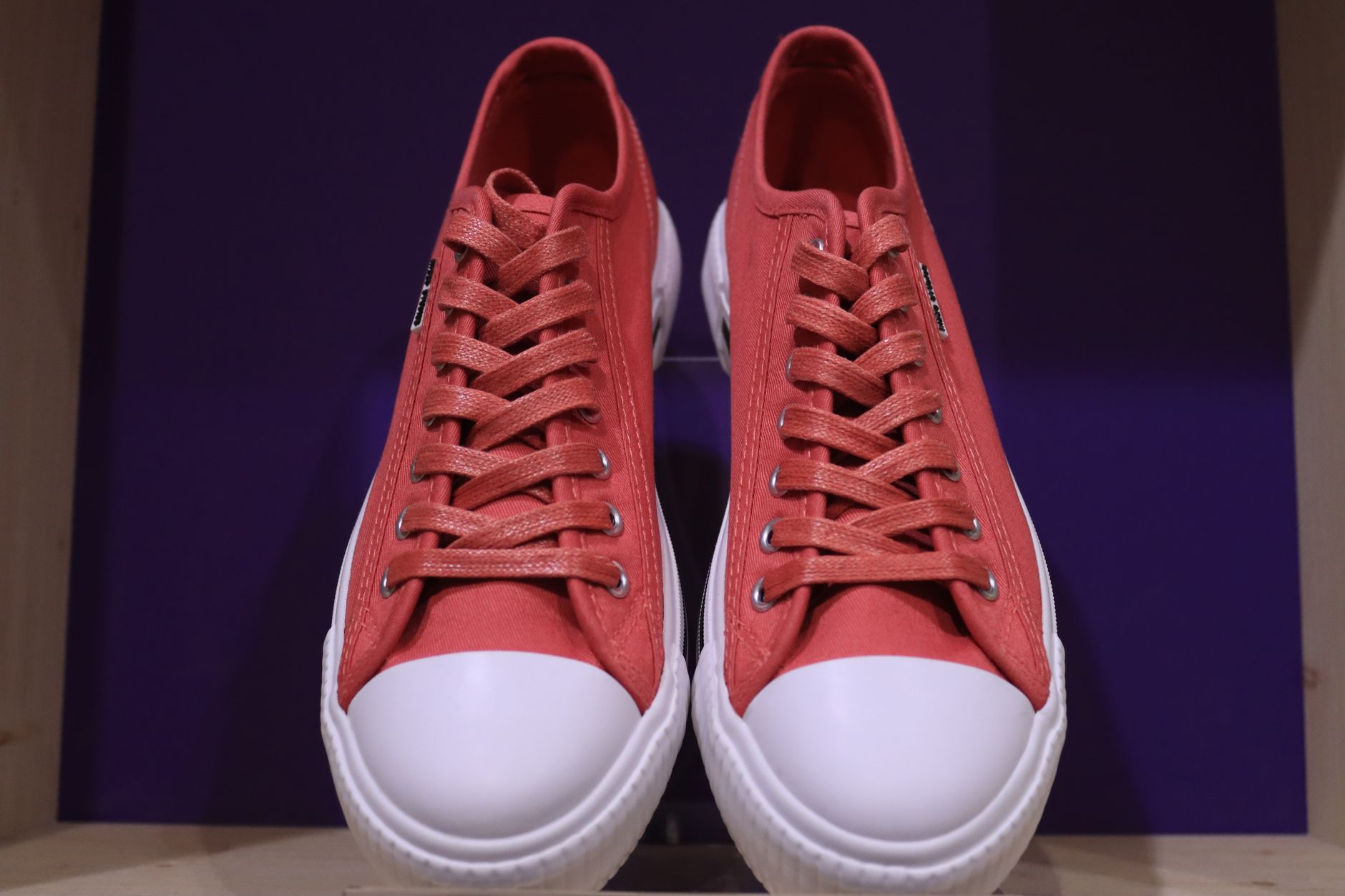 Row of athletic sneakers displayed on a retail shelf
