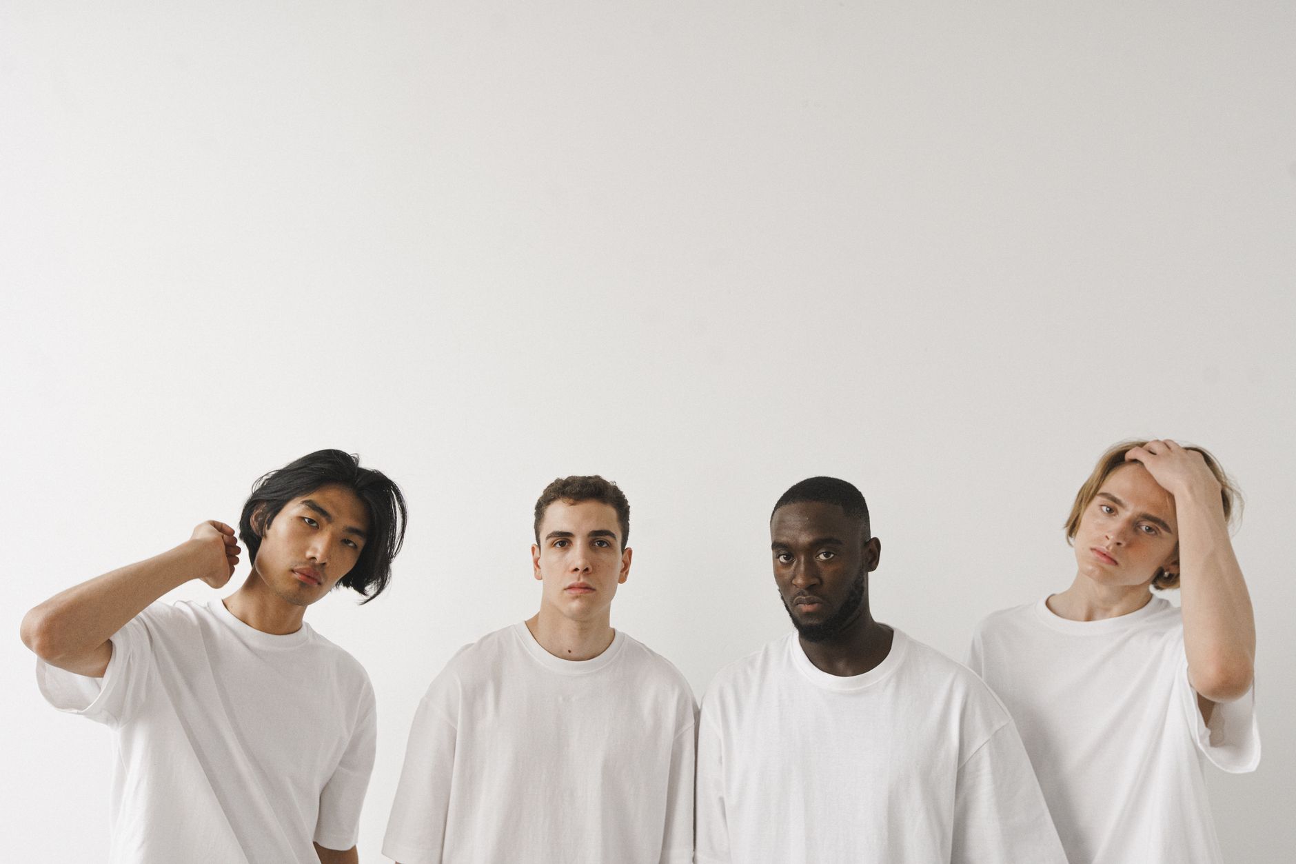 Simple white T-shirt laid flat on a neutral background