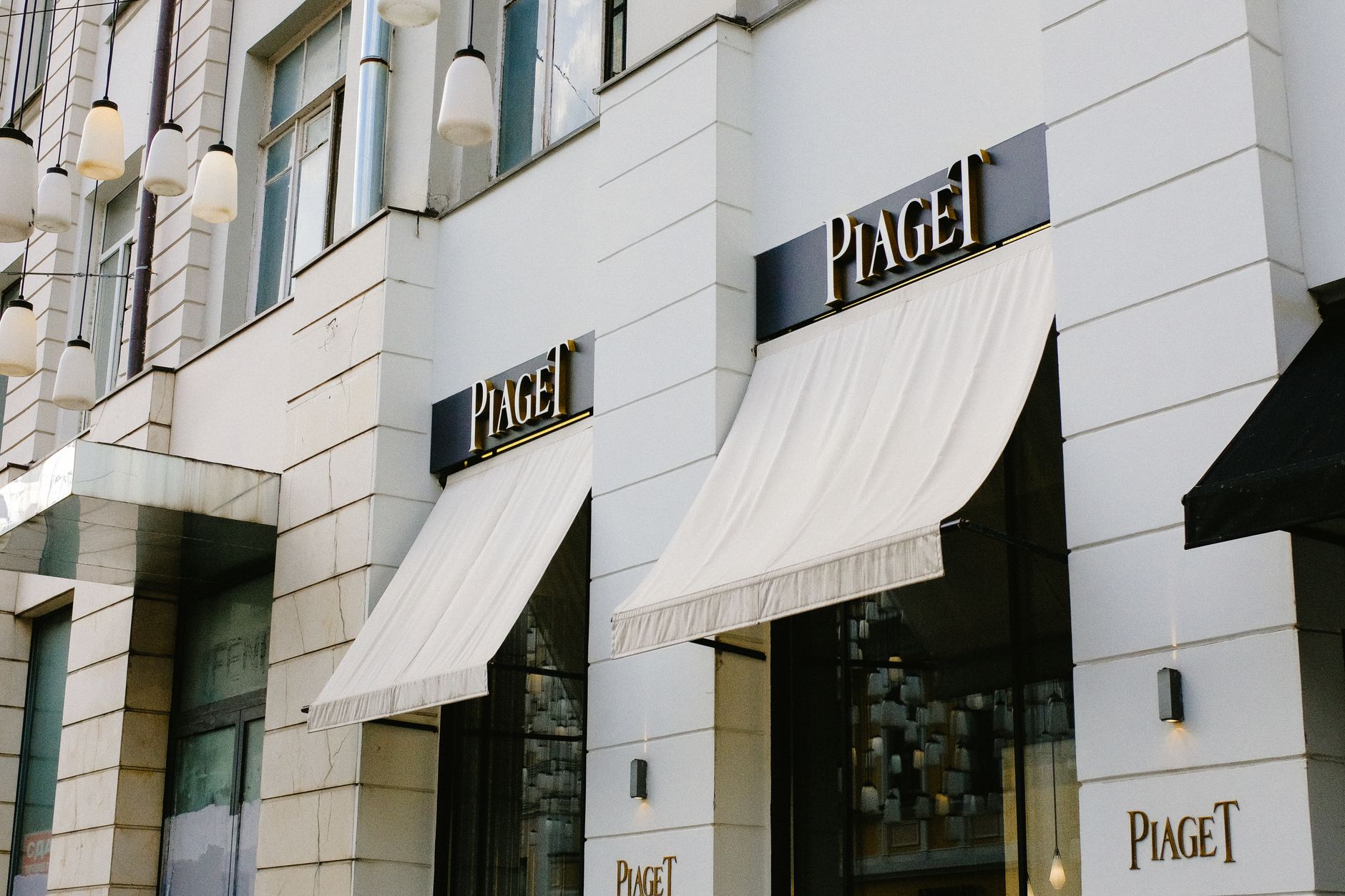 Designer clothing racks inside an upscale fashion retail environment