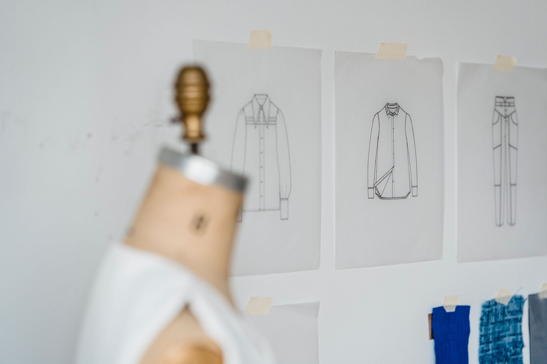A fashion designer's atelier with fabric swatches and tailoring tools on a worktable