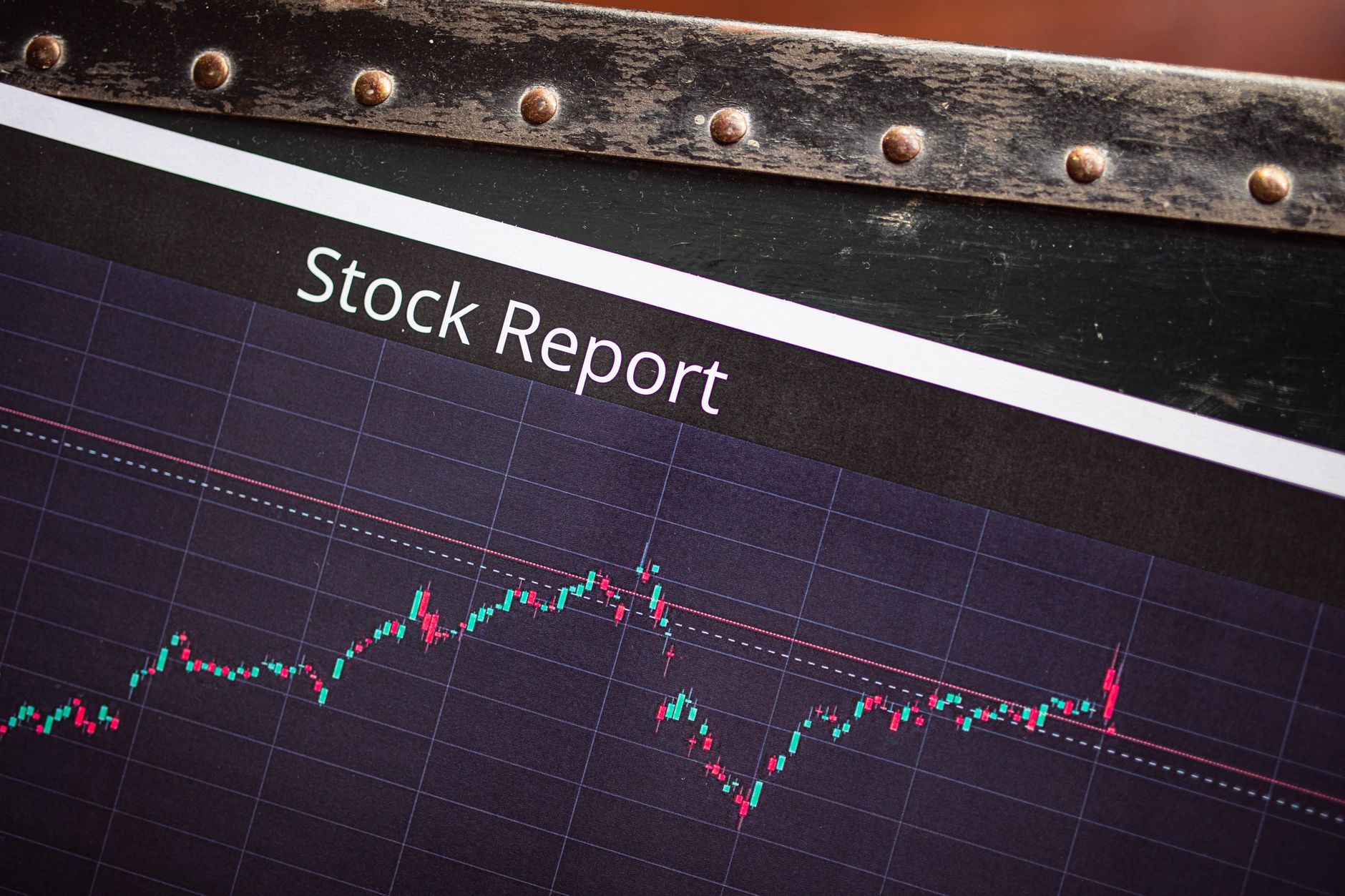 Analyst reviewing financial charts and data on multiple screens in a trading environment