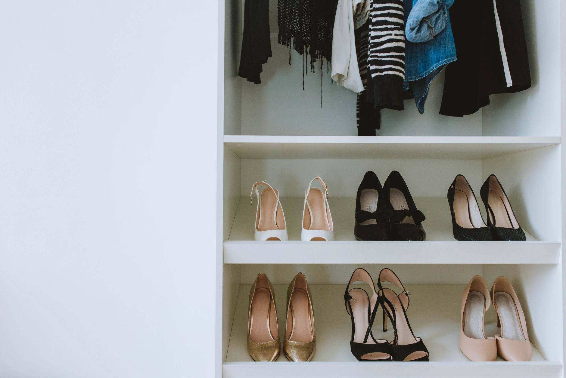 Assortment of designer heels and sandals arranged on a shelf