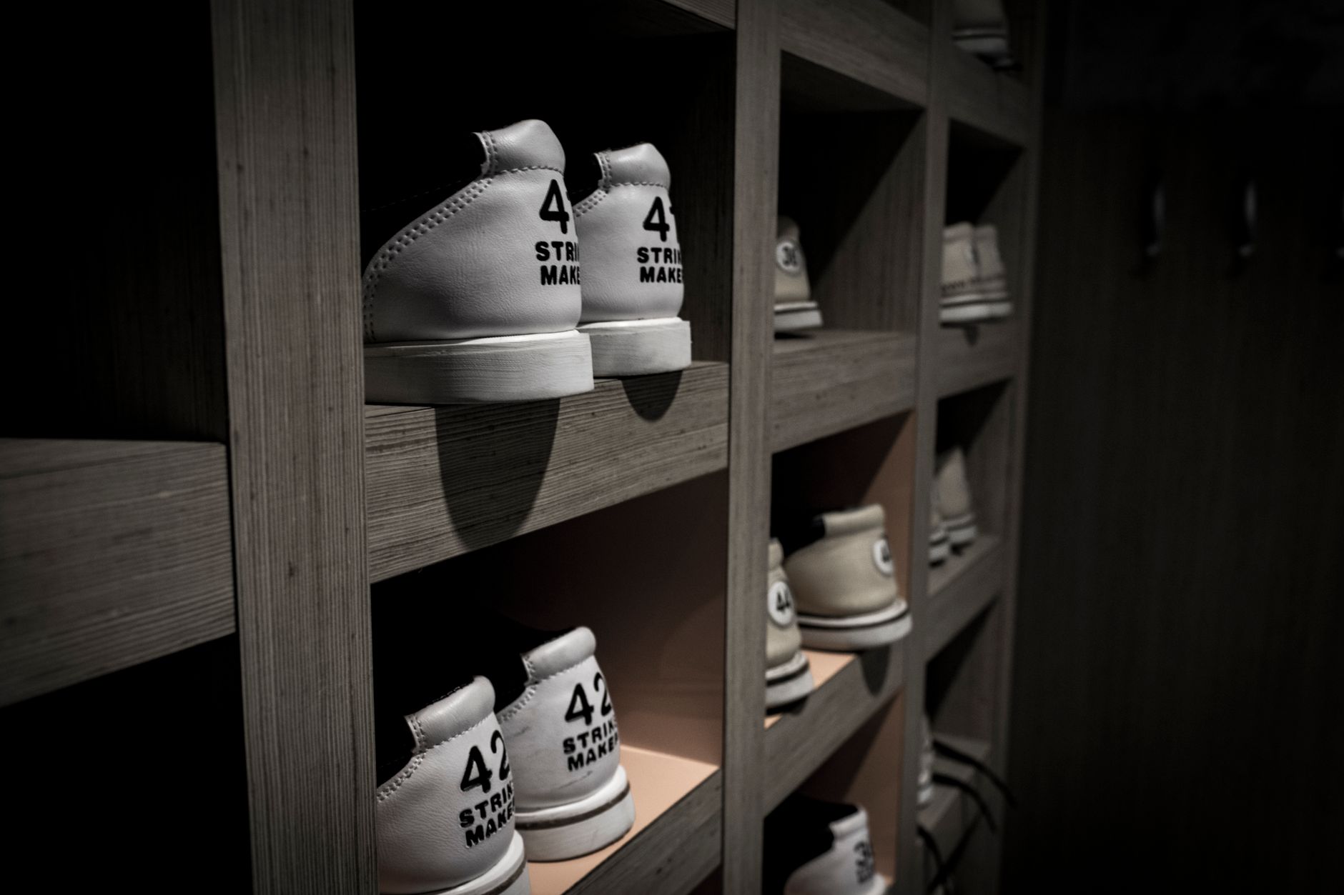 Sneakers displayed on shelves in a retail shoe store