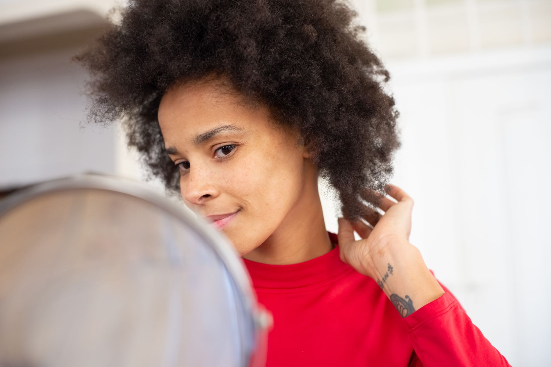 Close-up of Afro-textured hair being styled and cared for