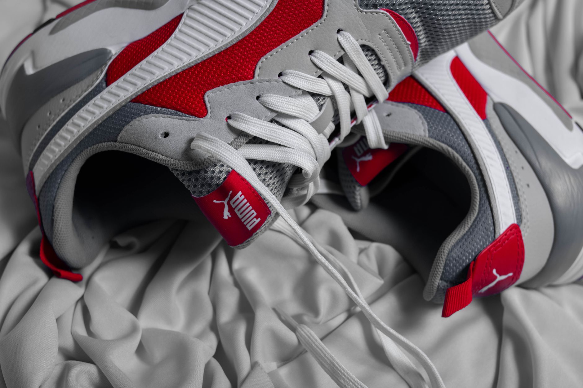 Close-up of avant-garde footwear strap detail on a neutral background
