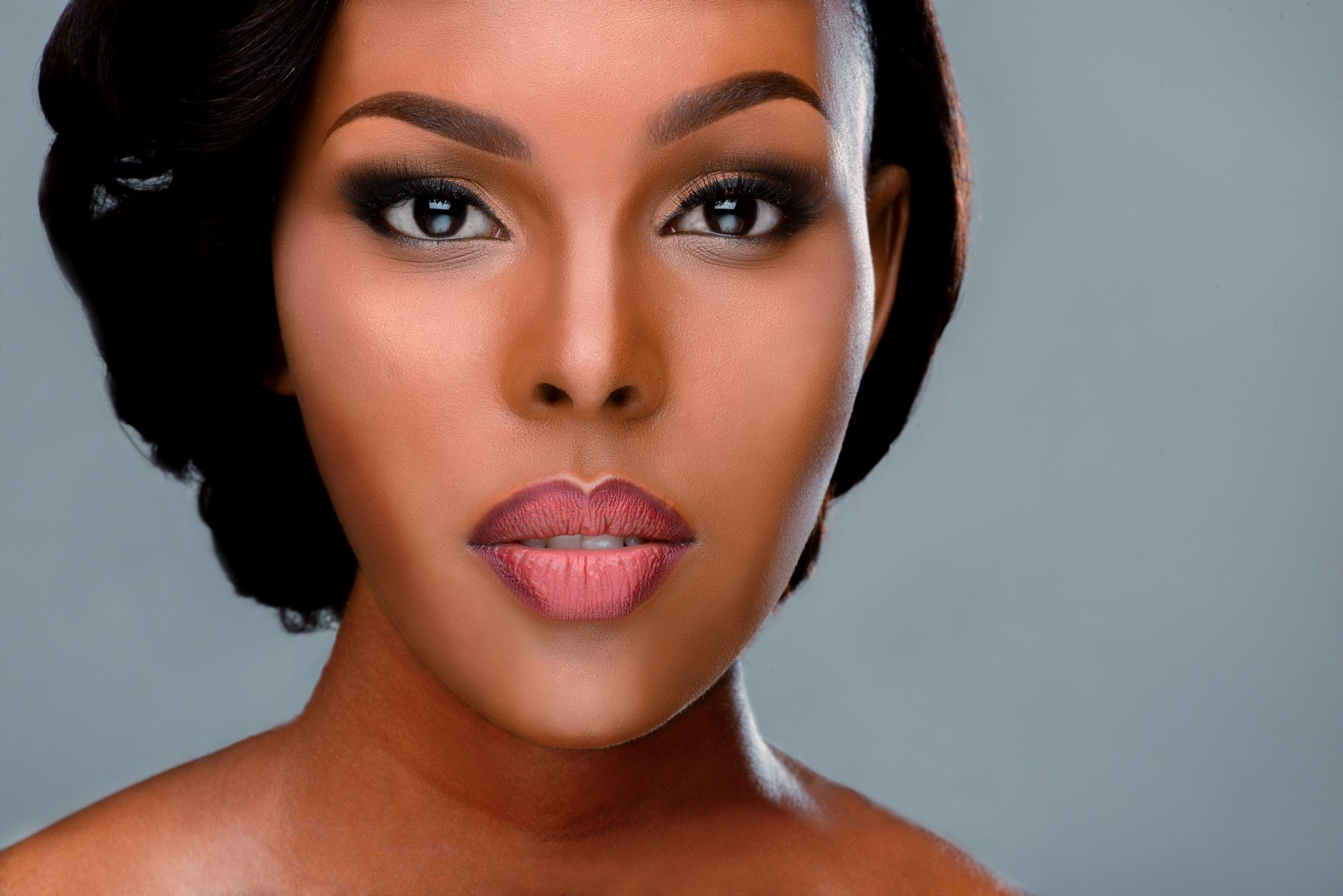 A woman with striking, unconventional makeup demonstrating fearless beauty reinvention