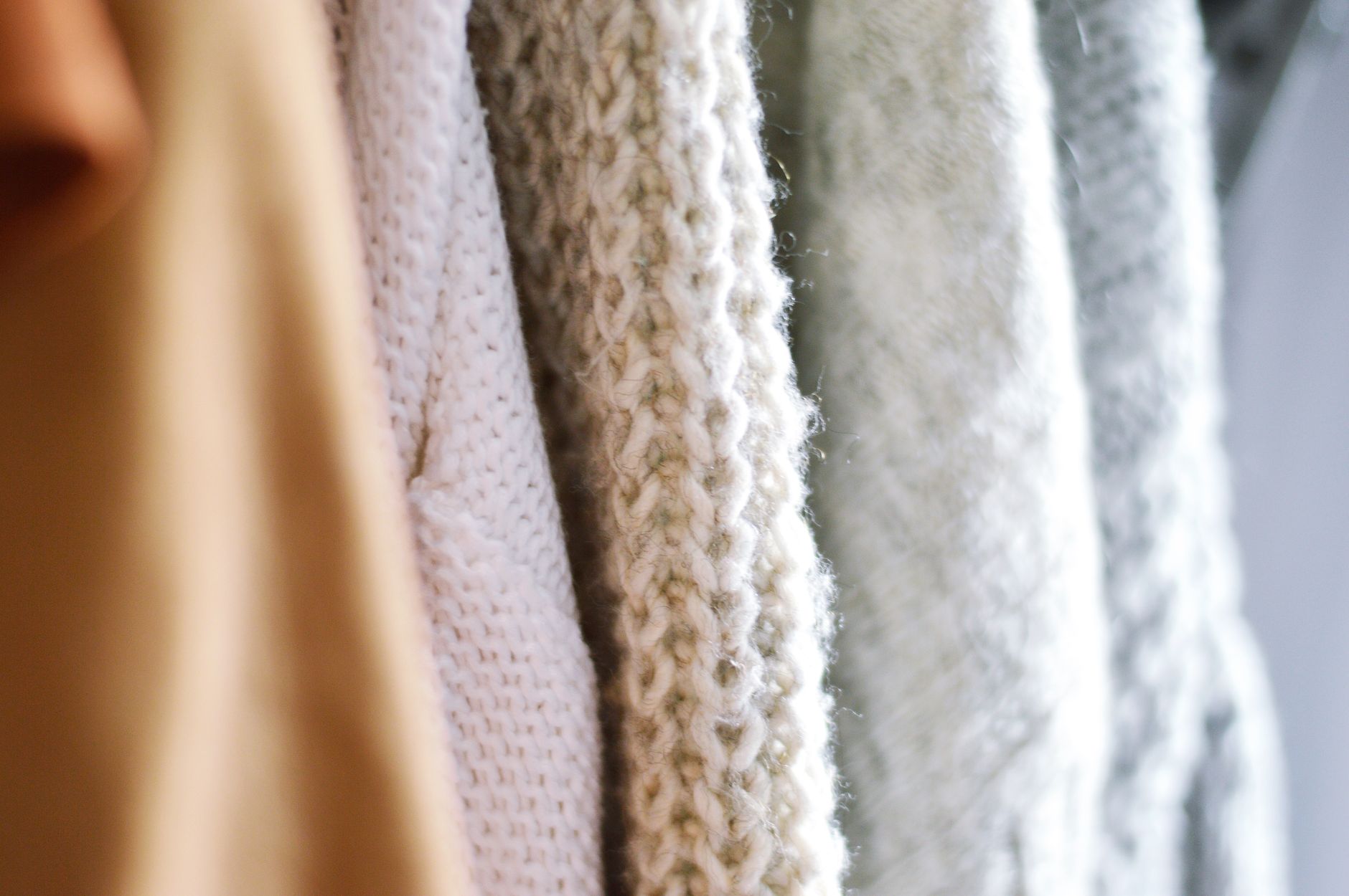 Neatly arranged fall garments in warm tones on a retail display