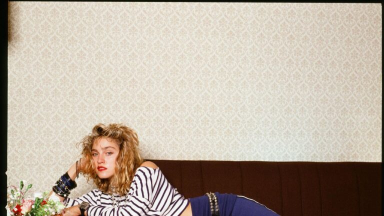 Madonna Embraced Decades of Beauty Reinvention Without Losing Herself. A woman in dramatic vintage makeup with bold lips and platinum hair, evoking 1980s pop icon beauty