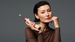 Is the Dyson Toothbrush Worth $499? We Asked 4 Dentists. Modern electric toothbrush resting on a clean white bathroom counter