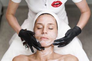 Esthetician performing a professional facial treatment in a clean spa setting