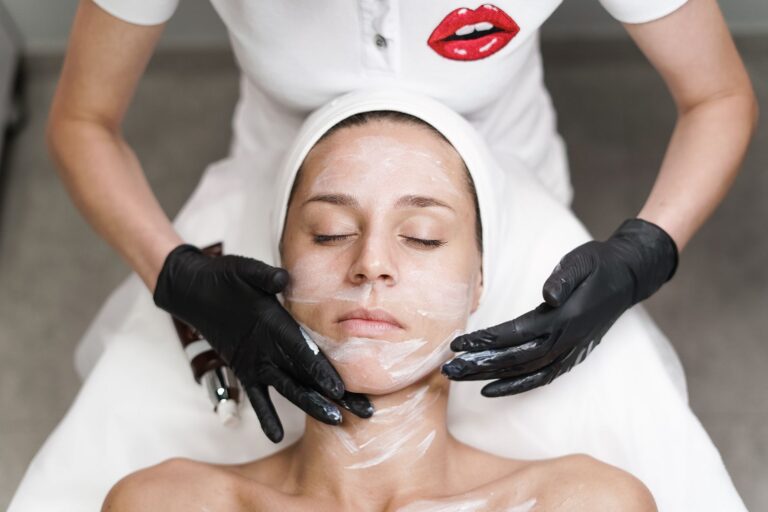 Esthetician performing a professional facial treatment in a clean spa setting